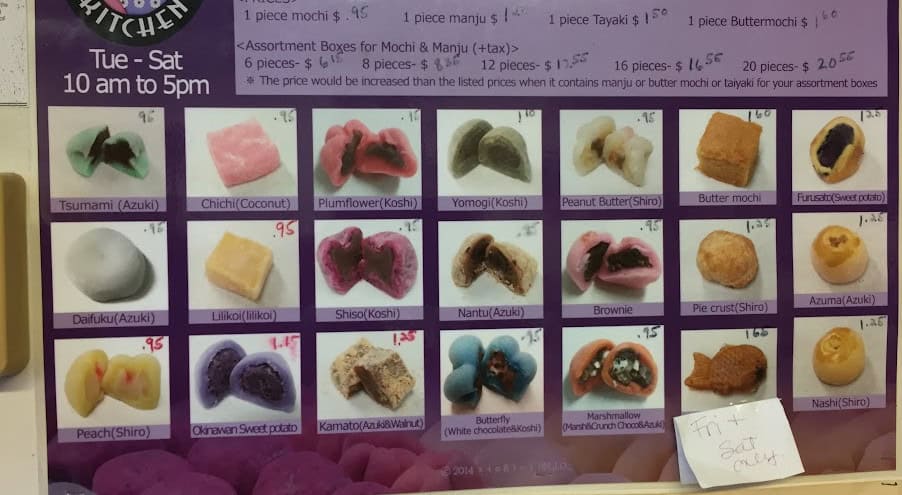 Menu board at 2 Ladies in Hilo, Hawaii. 21 color pictures of various mochi for sale in the shop.